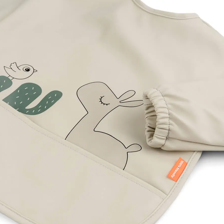 Done by Deer Sleeved pocket bib Lalee Sand